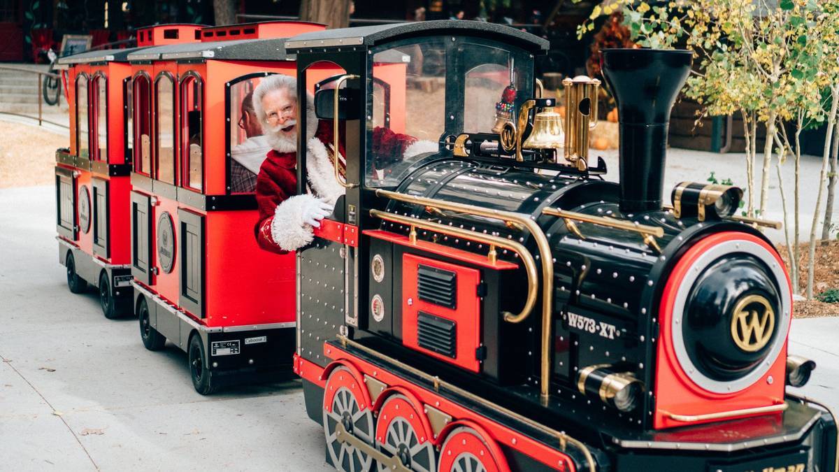 santa leaning out of a red and black train